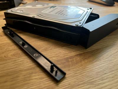 Grâce aux glissières, je peux facilement insérer mon disque dur dans le NAS, sans vis
